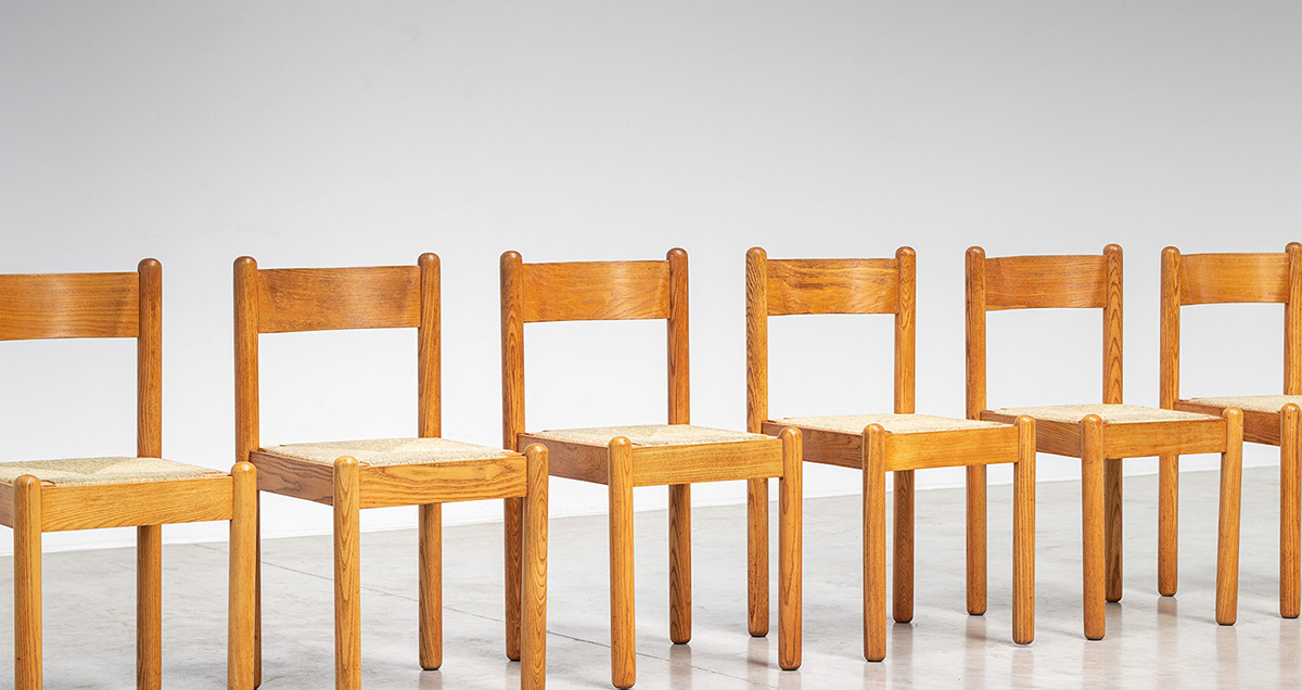 Six mid century dining chairs with hand woven rush seating. France, circa 1970. Solid oak wooden structure with curved plywood backrest made of pressure moulded veneer layers. The chairs have gained a original rich patina through the years.