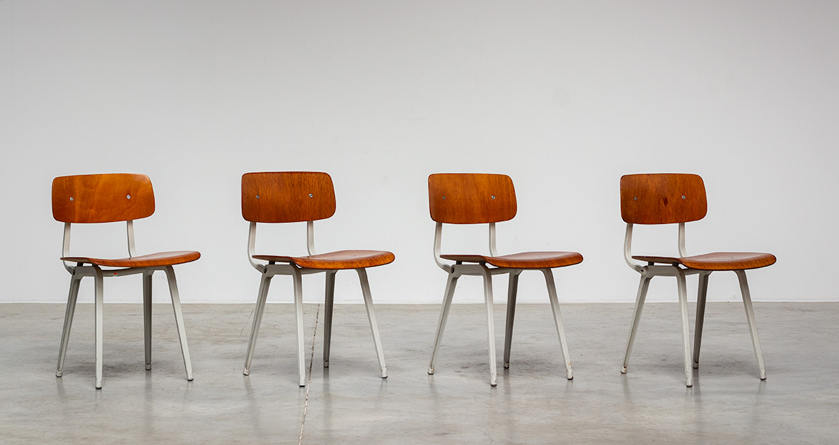 Set of four original Revolt dining chairs, designed by Friso Kramer and manufactured by Ahrend de Cirkel. Unveiled in 1953, the iconic Revolt chairs production started in 1958. The wooden version is a rare version and produced in limited numbers and no more in production.